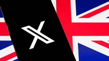 X logo on smartphone screen over British flag